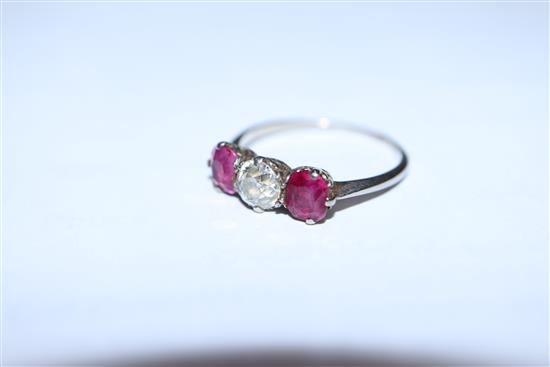 A white metal, ruby and diamond three stone ring, (shank cut).